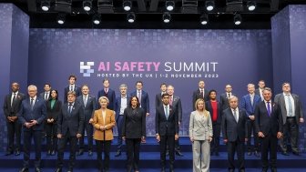 A group of world leaders positioned in front of a AI Safety Summit sign in November 2023.
